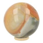 Mooie, zacht gekleurde polychroomjaspis bol met diameter van bijna 9,5cm en natuurlijke holte, inclusief houten ring