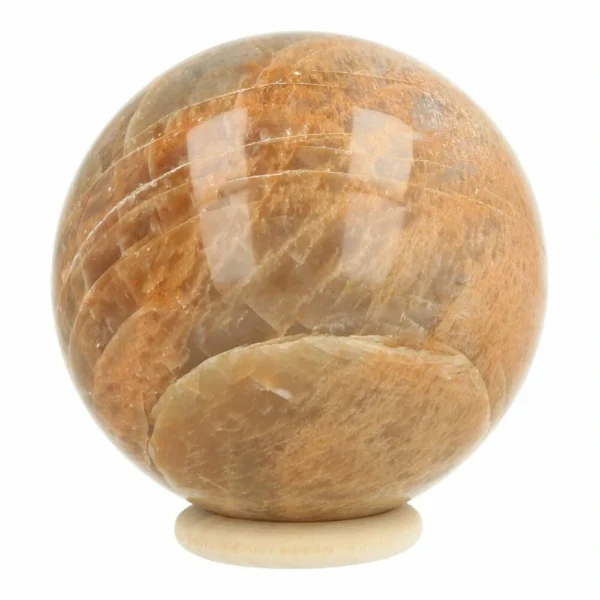 Mooie perzik maansteen bol met diameter van 68mm op houten ring